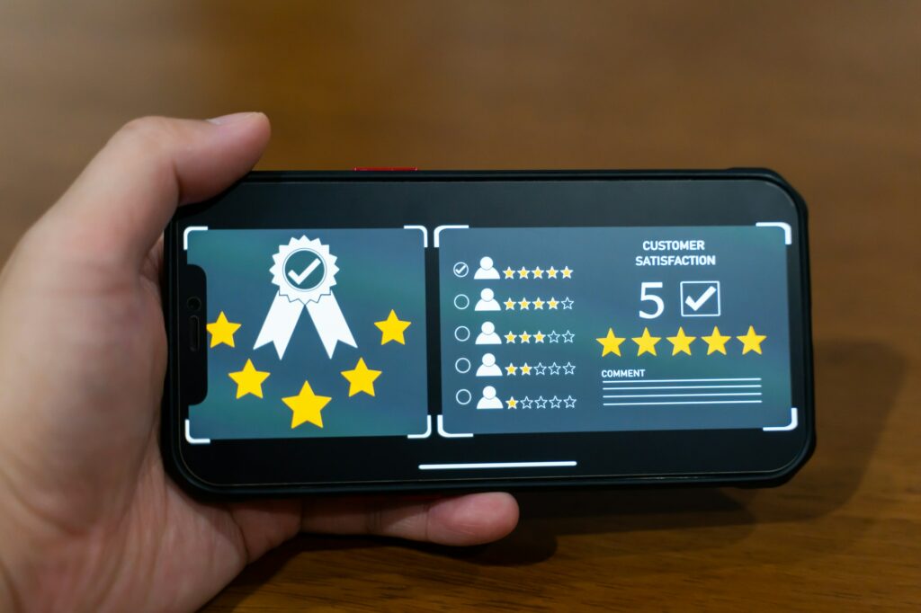 Customer review good rating concept, smile face and five star on screen for positive feedback.