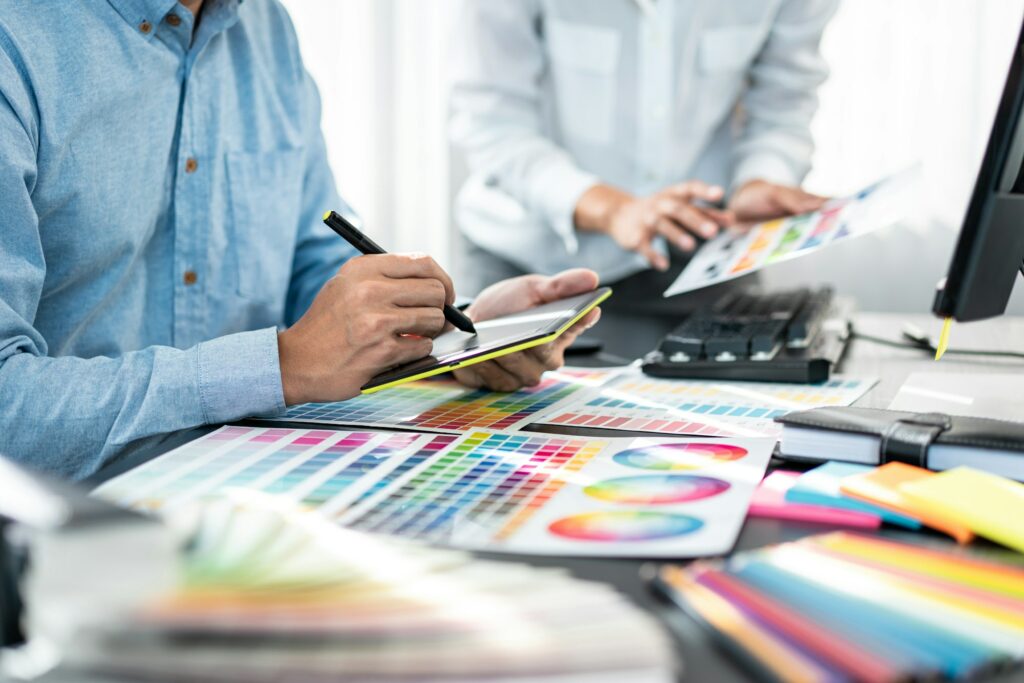 Team of creative graphic designer working on color swatch samples chart for selection coloring